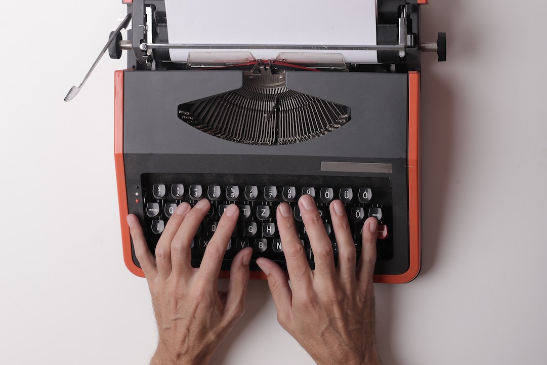 email content - hands on a red typewriter - Photo by Andrea Piacquadio - Pexels