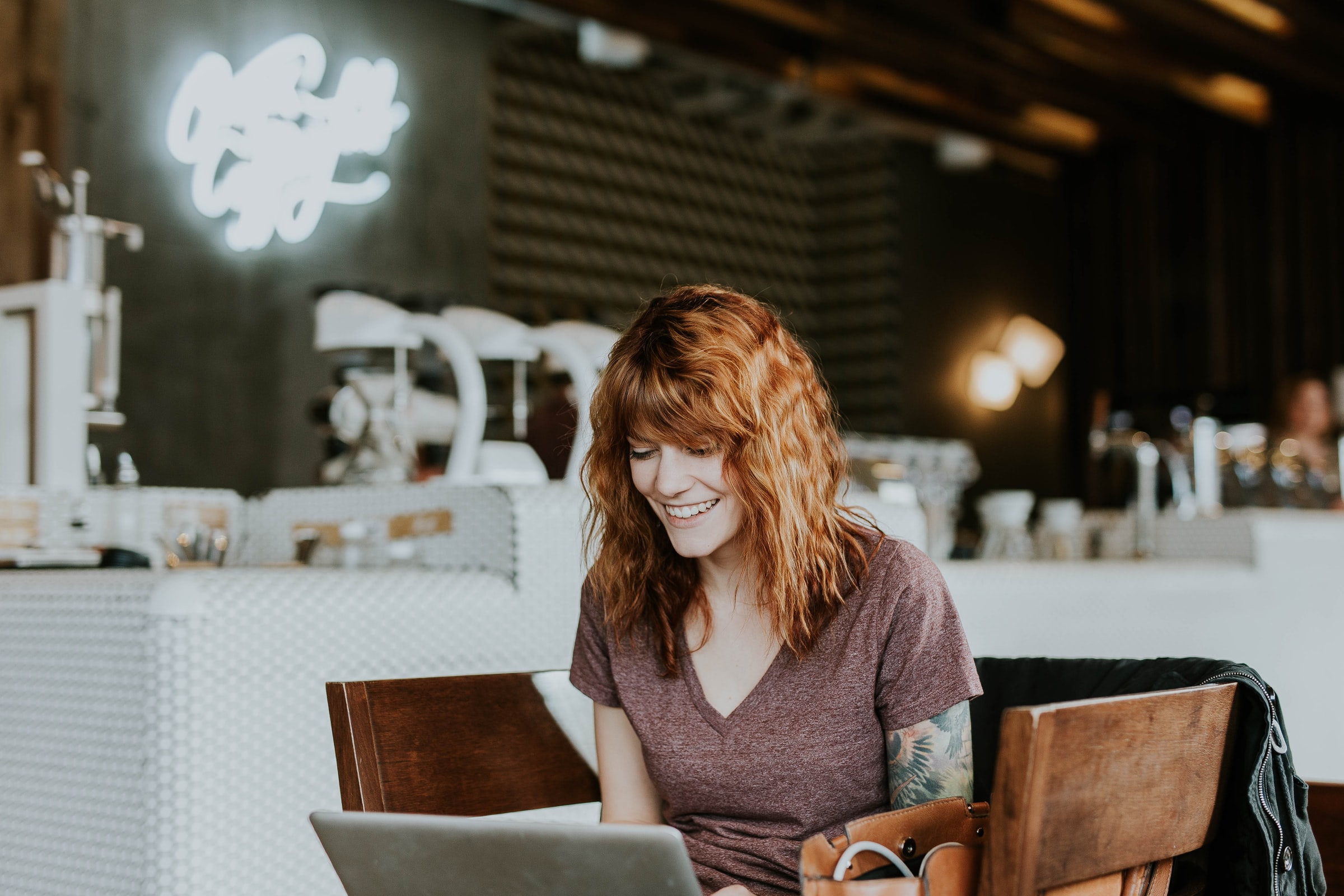 Emails you need to send - Lady with a smile infront of a computer
