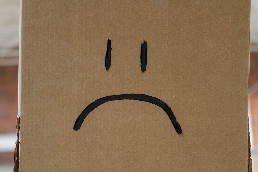 Complaints - avoid them - Unhappy face on a box