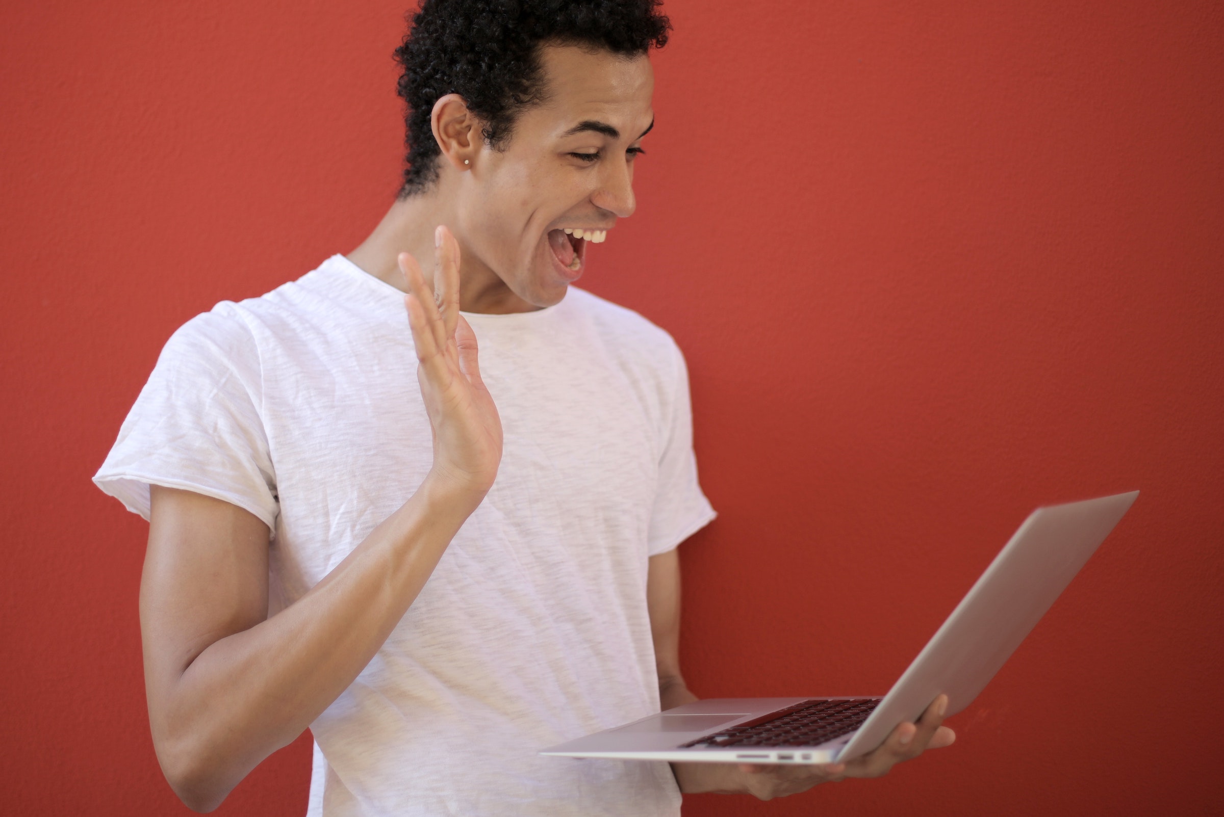 Man smiling at a computer happy to see his personalized email - Photo by Andrea Piacquadio - Pixels