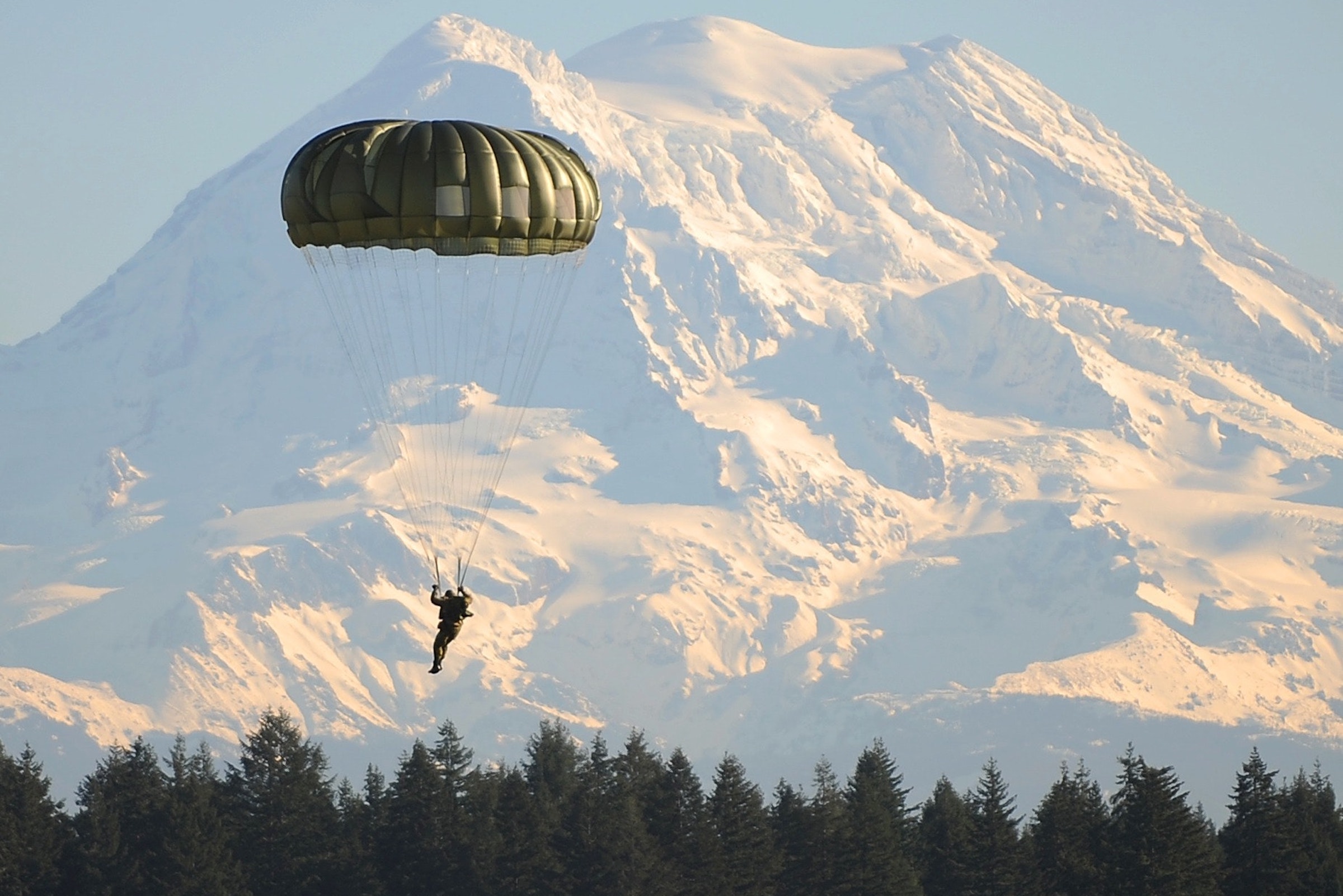 Parachute landing infront of a mountain